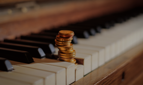 Money-on-piano-pressing-down-piano-key